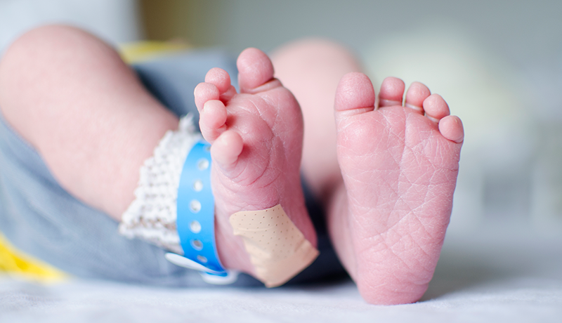 newborn feet with band aid