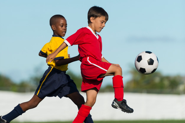 Two boys playing soccer