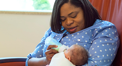 mom feeding newborn in NICU