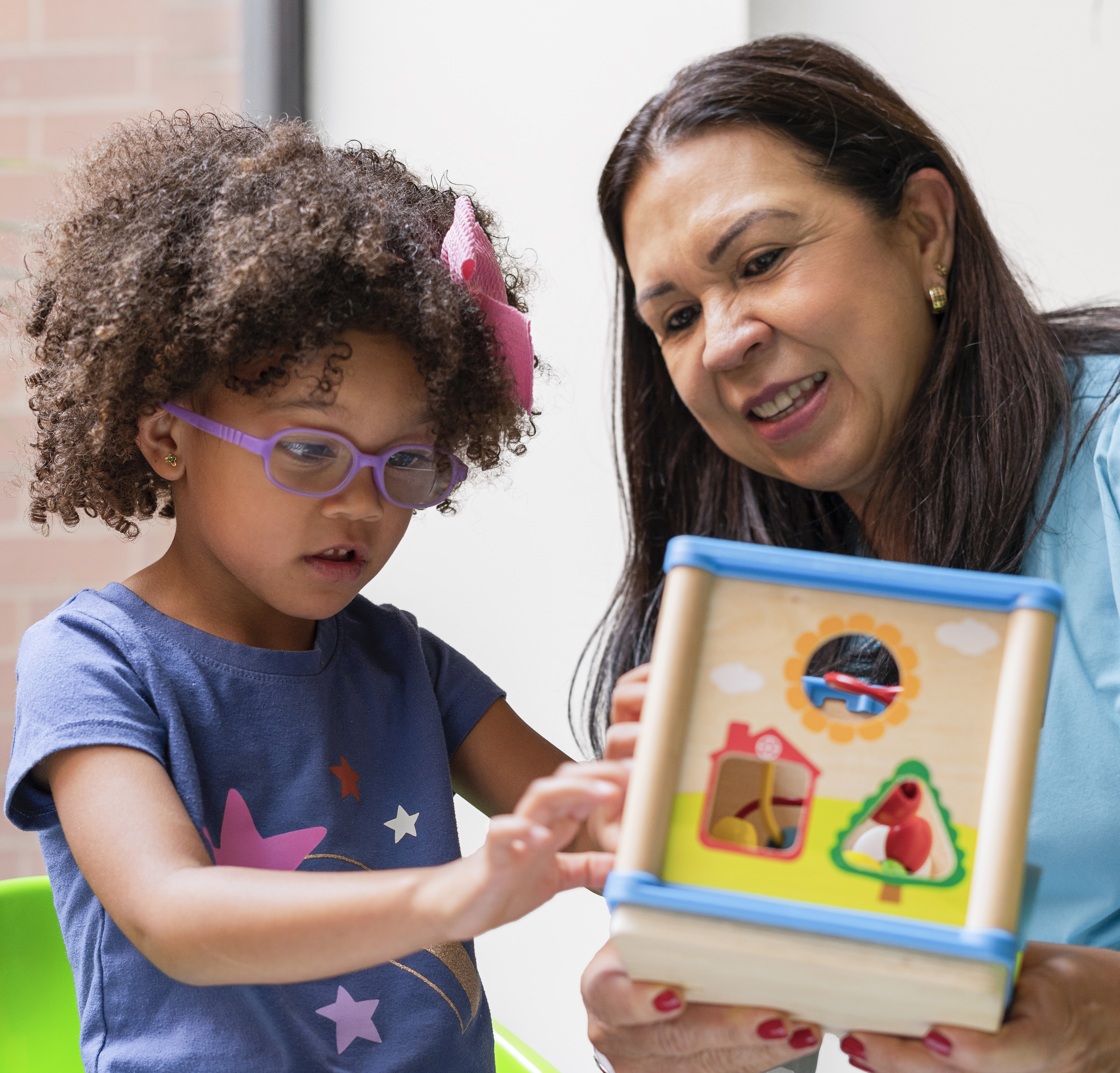 pediatric neurology image of young girl playing with toy